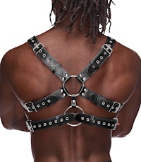 the back view of a man wearing a black leather harness