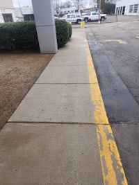 a sidewalk with a yellow line on it