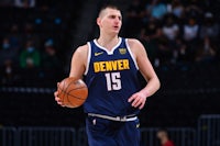 denver nuggets player holding a basketball during a game