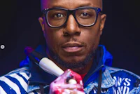 a black man with glasses holding a baseball bat