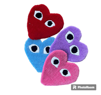 four heart shaped stuffed animals with eyes on them