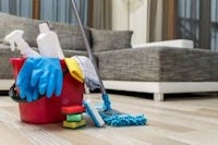 a bucket of cleaning supplies on a wooden floor