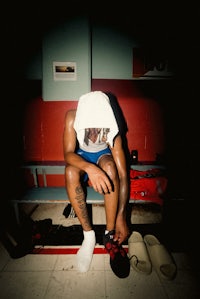 a man sitting on a bench with his shoes on