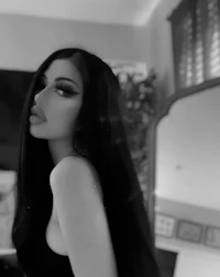 a black and white photo of a woman with long black hair