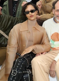 a man and woman sitting next to each other at a fashion show