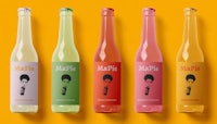 a row of bottles with different colored liquids on a yellow background