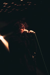 a man is singing into a microphone