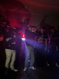 a group of people standing in a dark room