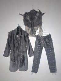 a pair of jeans and a jacket hanging on a wall