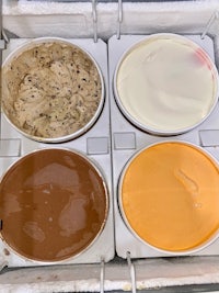 four different flavors of ice cream in a plastic container