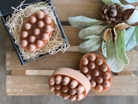 a box of soap with pine cones in it