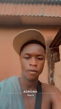 a young man wearing a hat and a cap