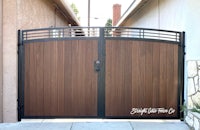 a wooden gate in front of a house