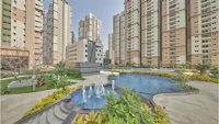 an apartment complex with a swimming pool and a fountain