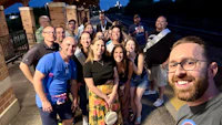 a group of people posing for a selfie at a train station