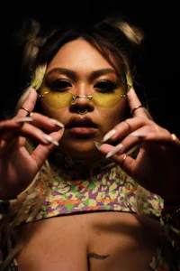 a woman in a colorful outfit holding her hands up