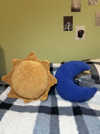a crocheted sun and moon on a bed