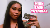 a woman holding up a box of mink lashes