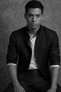 a black and white photo of a man in a suit