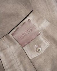 a close up of a brown leather jacket with a label on it