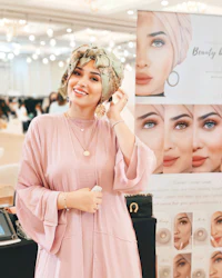 a woman wearing a hijab posing for a photo