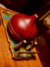 a wooden table with a bottle of essential oil on it