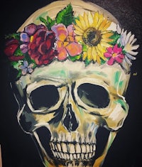 a painting of a skull with flowers on it