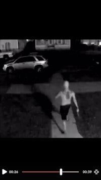 a man is running down a sidewalk in a dark area