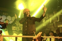 a man with a microphone in front of a crowd of people