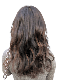 the back view of a woman's hair with long wavy hair