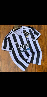 a black and white juventus soccer jersey on a wooden table