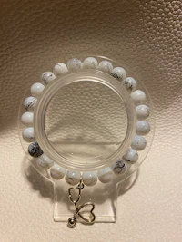 a bracelet with a heart shaped bead on it