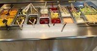 a counter with a variety of dips on it