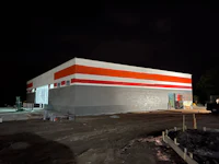 an orange and white building under construction at night