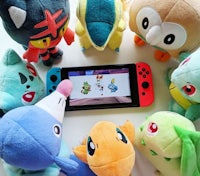 a group of stuffed animals surrounded by a nintendo switch
