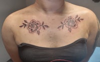 a woman with a tattoo of roses on her chest