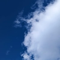 a blue sky with white clouds in the background