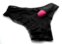 a black pantyhose with a pink button on it