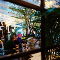 a group of people sitting at a table in a restaurant