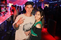 a man and woman posing for a photo at a night club