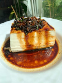 a white plate with a piece of food on it