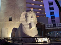 a statue of an egyptian sphinx in front of a building