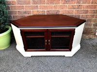 a white and brown tv stand with two doors