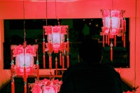 a man looking at a group of red lanterns