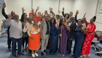 a group of people posing for a photo in an office