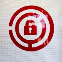 a red padlock on a brick wall