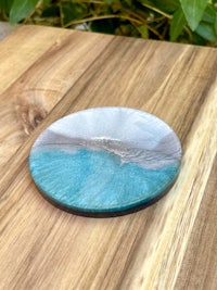 a blue and grey coaster sitting on a wooden table