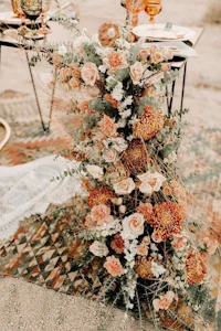 a table set up with flowers in the desert