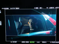 a man sitting in a car looking at the camera