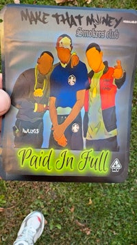 a bag with a picture of a man holding a pack of marijuana